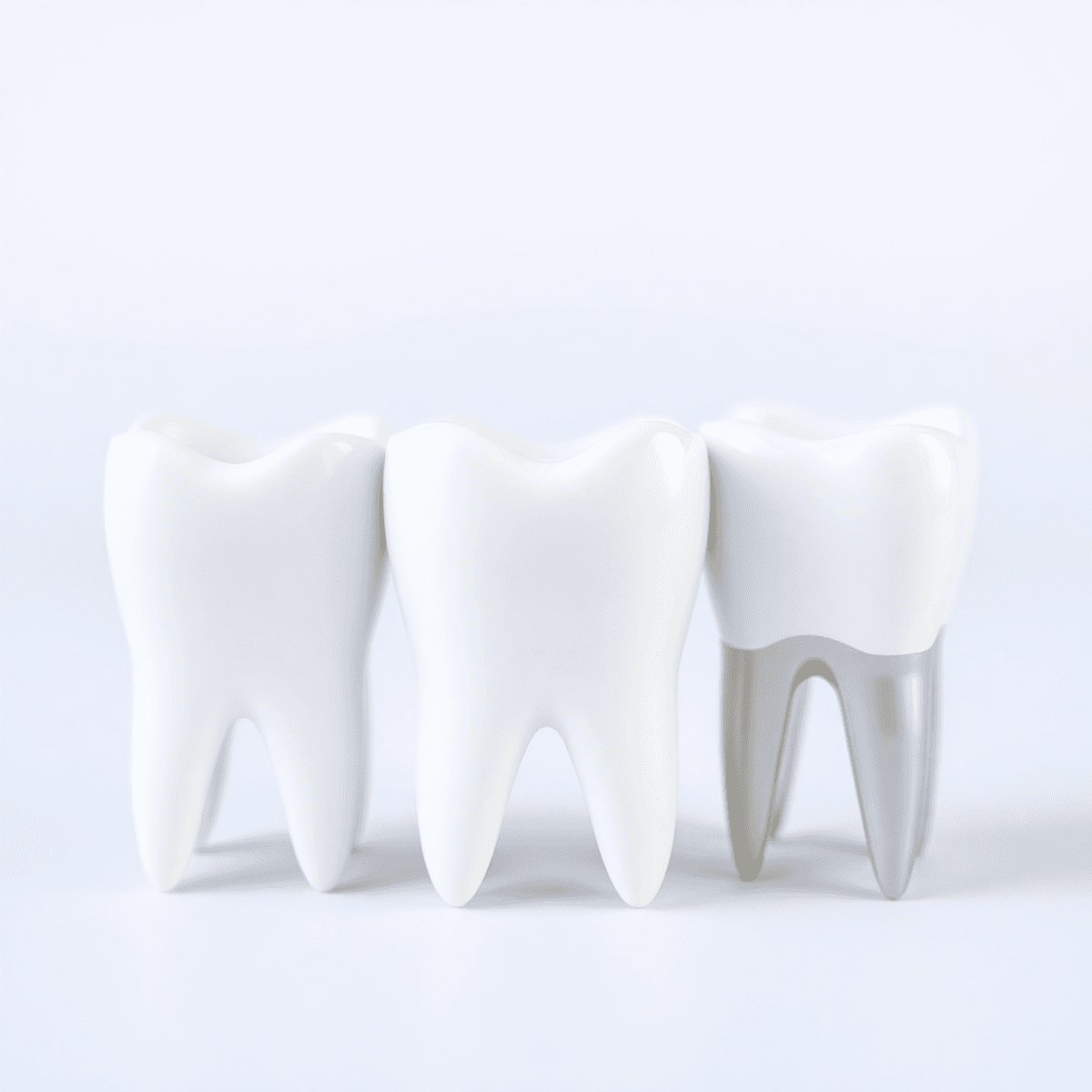 Close-up of three stylized dental crowns side by side, showing zirconia, E-Max ceramic, and metal-ceramic materials with a soft, clean background.